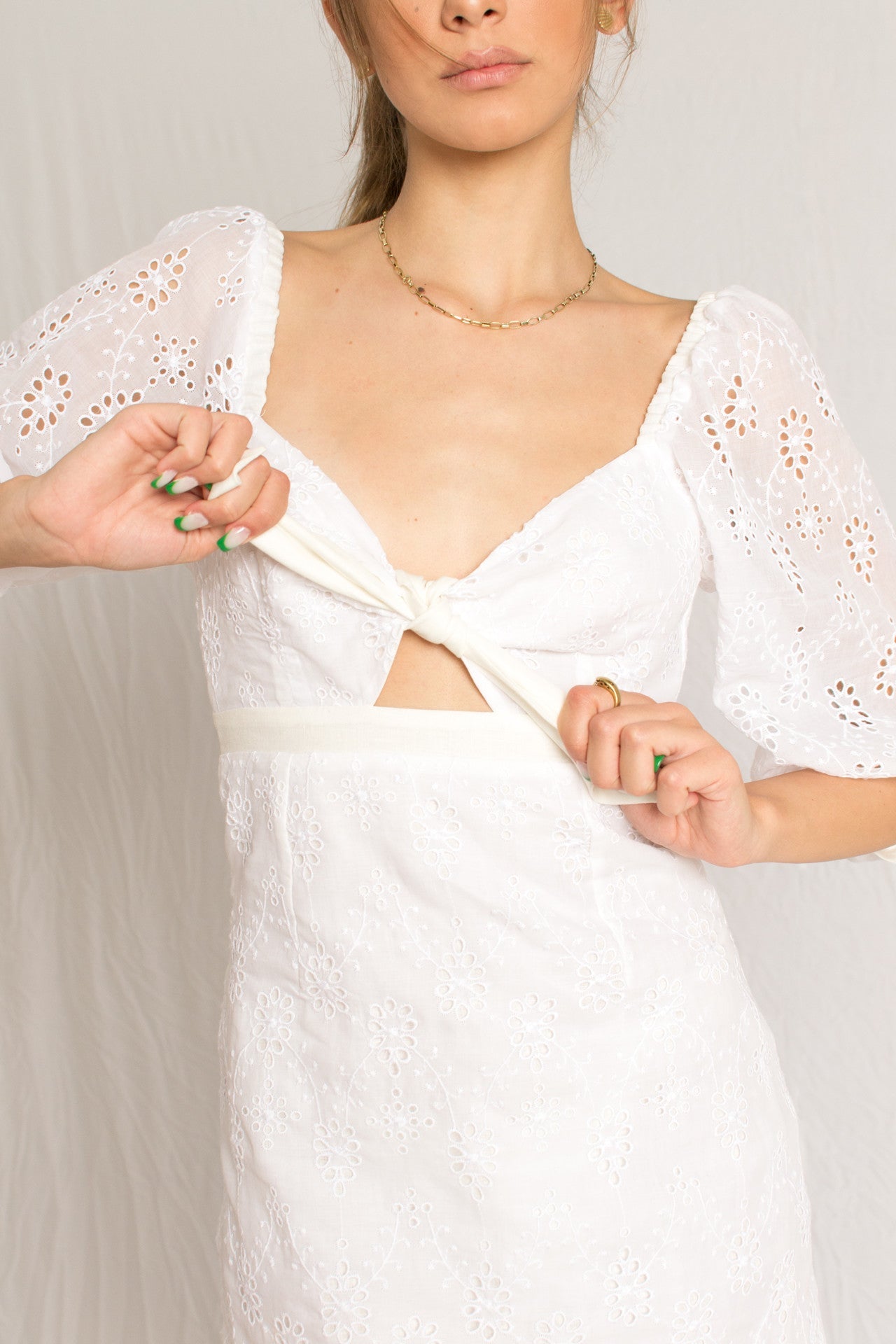 Short white mini dress with peasant sleeves and dainty embossing